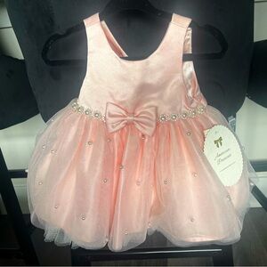 6-9 months. Light pink/peach dress.